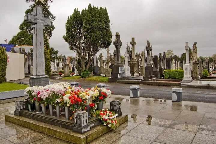 Numerous gravestones and a flower-covered grave in Glasnevin Cemetery